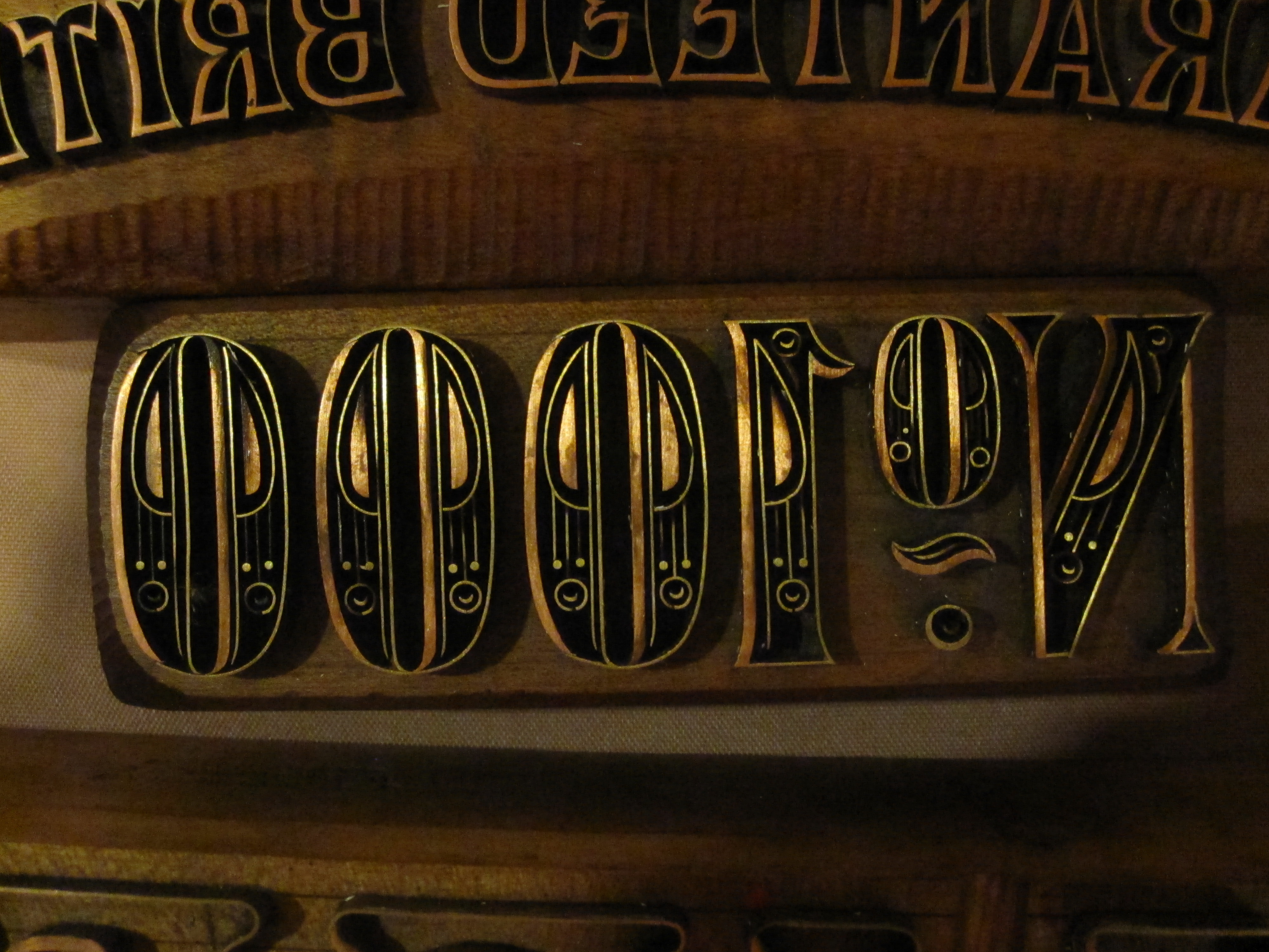 Woodblock typography, mirrored horizontally as it would appear when used on paper.